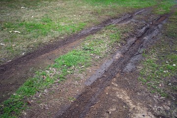 Tyre marks in a wet muddy ground 