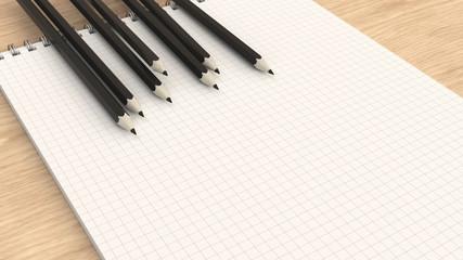Notebook with black pencils