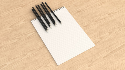 Notebook with black pencils