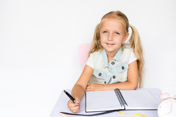Back to school and happy time. Children holding pen and writting in notebook on white background....