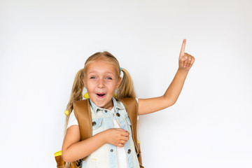 Back to school and happy time. Cute child with blonde hair on white background. Kid with backpack. Girl ready to study. Mockup, place for text, education concept