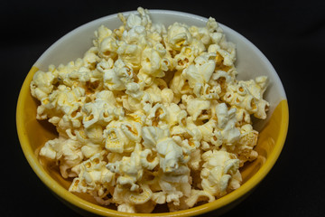 Popcorn is a snack made from corn kernels it is white color popular for people in many countries.