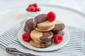 Sweet delicious ice cream cookie sandwiches on table