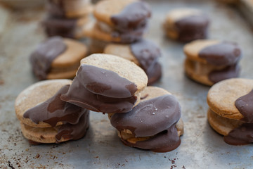Sweet delicious ice cream cookie sandwiches on table