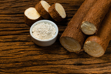 Raw Cassava. Pieces of Manihot esculenta. Wooden background old.