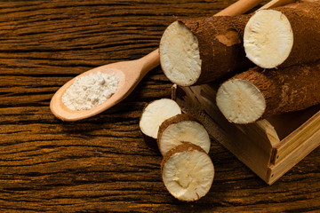 Raw Cassava. Pieces of Manihot esculenta. Wooden background old