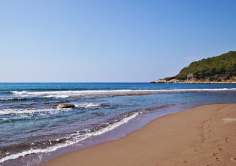Seashore in Turkey. Summer beach with stones in the bay of the ocean.