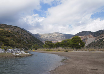 Seashore in Turkey. Summer beach with stones in the bay of the ocean.