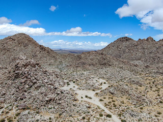 Aerial view of empty dirt road in the arid desert. Off road in the desert. Joshua Tree National Park. American national park in southeastern California, USA.