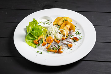 herring with baked potato and sauce