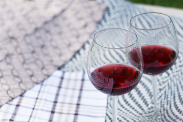 Two glasses with red wine on a beautiful tablecloth. Top view of alcoholic drink.