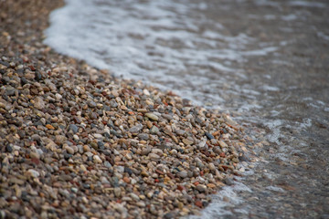 small stones on the beach with water