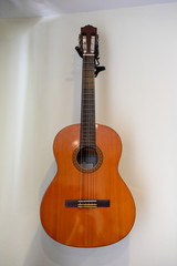 Fototapeta na wymiar Acoustic guitar hanging decorative on wall