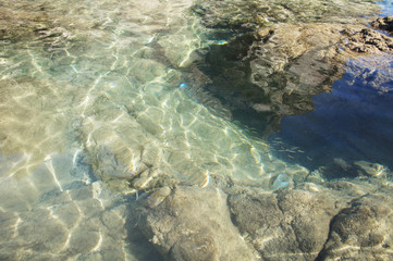 Blue azure lagoon with clear water on the sea coast.