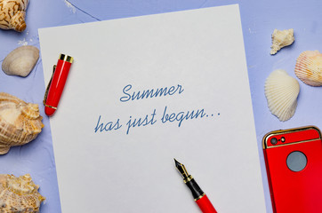 background with seashells a white sheet of paper with the inscription pen red pen and red phone