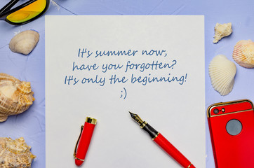 background with seashells a white sheet of paper with the inscription pen red pen and red phone