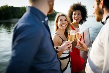 Group of happy people or friends having fun at party
