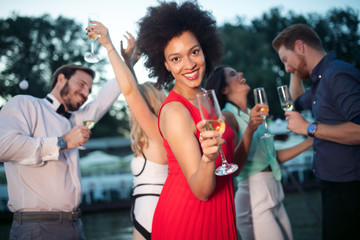 Group of happy people or friends having fun at party