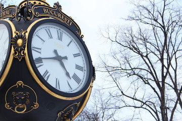 Fototapeta na wymiar Clock monument in Herastrau Park in Bucharest, Romania in winter season. Bucuresti means Bucharest in Romanian.