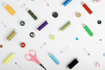 White background with different tools for sewing and tailoring