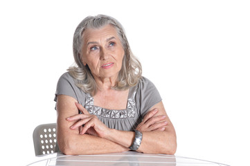 Portrait of emotional senior woman at table