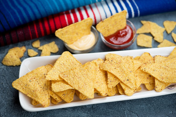 Mexican nachos chips with dipping sauces, close-up, horizontal shot, selective focus