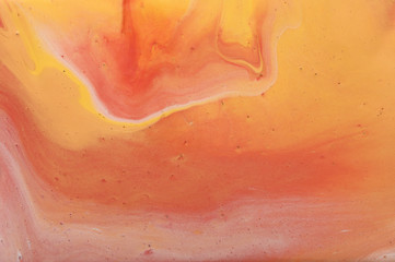 photography of abstract marbleized effect background. gold, yellow, orange and white creative...