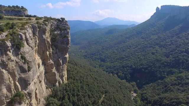 Aerial views to a deep valley with natural cliff in Rupit and Pruit. View to Guilleries, Montseny, the cliffs of Tavertet, Avenc and El Far. Surrounded by nature, rivers and waterfalls
