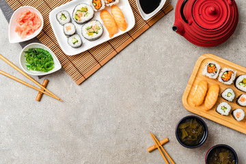 Traditional sushi set with teapot. Food background