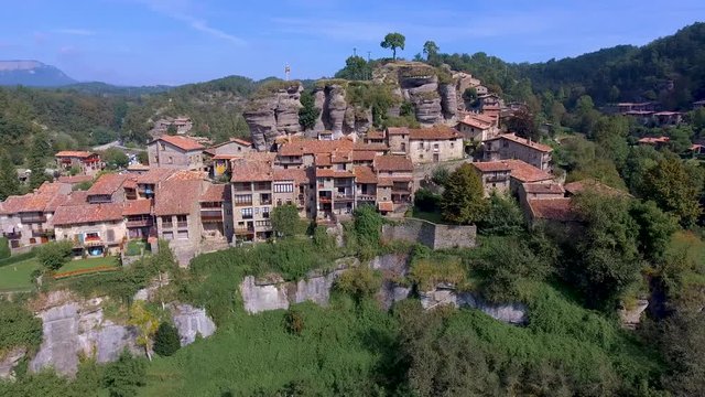 Aerial landscape around a stone village stopped in the middle of the medieval Collsacabra. Catalonia, Spain