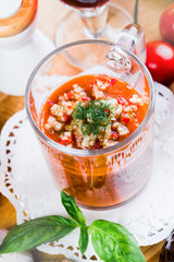 Tomato soup with fresh ingredients in a soup cup