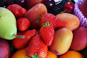 top view of assorted fruit strawberries cherries pear orange and apricot