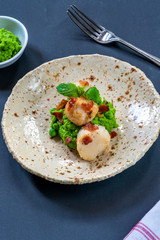 Scallops with minted peas and crispy pancetta - high angle view