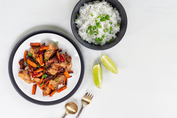 Teriyaki chicken, lime and bowl of rice on a white background