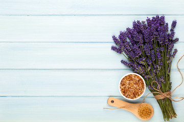 Grooming products and fresh lavender bouquet on white wooden table background.