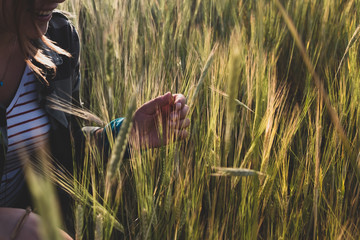 woman is sitting in barley field