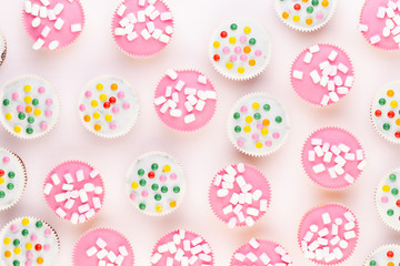 Colorful cupcakes on a white background.