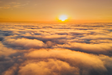 Obraz premium Beautiful misty dawn. Flying above the clouds, drone video