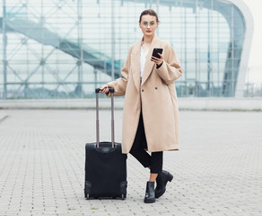 . Business woman at international airport moving to terminal gate for airplane travel trip -...