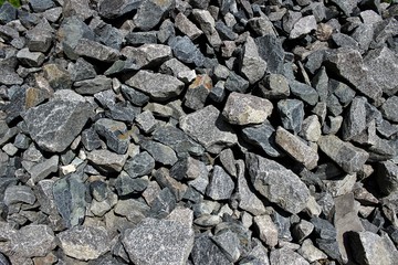 Pieces of granite of different shapes folded into a pile.