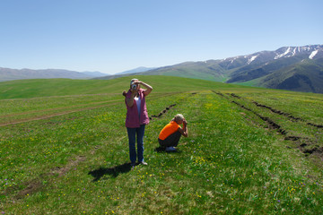 Two tourist woman photographing mountains