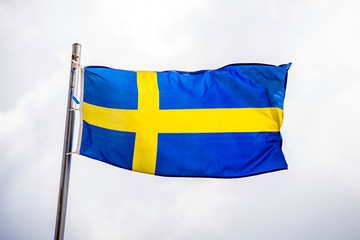  Flag Of Sweden fluttering on a metal flagpole 