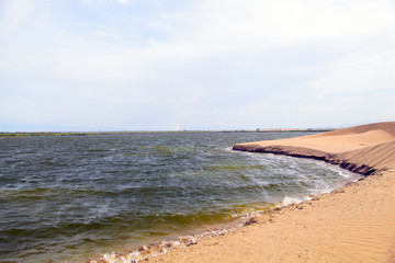 Lake and sand in a windy day