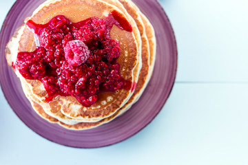Healthy breakfast,homemade classic pancakes with fresh raspberry jam. top view