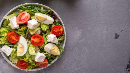 Vegetable salad with eggs  and cheese. Healthy food.  Top view. Copyspace
