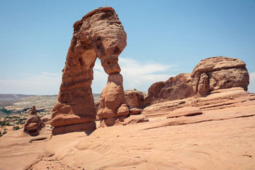 Delicate Arch seen from eastern side on hot summer day in Arches National Park, Utah.