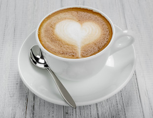 Cup of coffee latte and coffee beans isolated