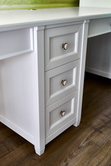Kids desk with drawers. Classic children's furniture in white color close-up