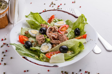 Fresh salad with iceberg lettuce,tomatoes,eggs,canned tuna and olives