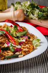 Mexican salad with hot pepper chiken fillet lettuce on plate